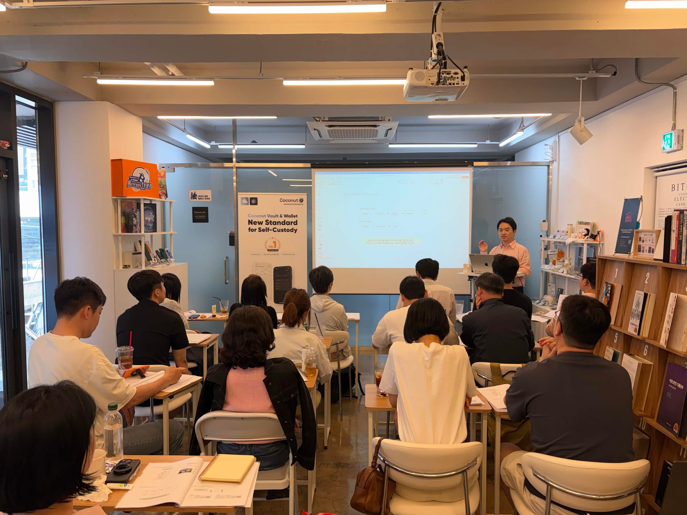 Participants attending a class in the center, with the presenter on the right